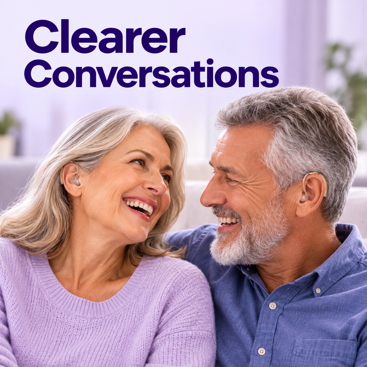 Smiling older couple on a sofa, each wearing a LUMANA rechargeable hearing aid sound amplifier behind the ear, with the text Clearer Conversations