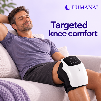 Man relaxing on a sofa wearing the LUMANA heated knee massager with touchscreen controls