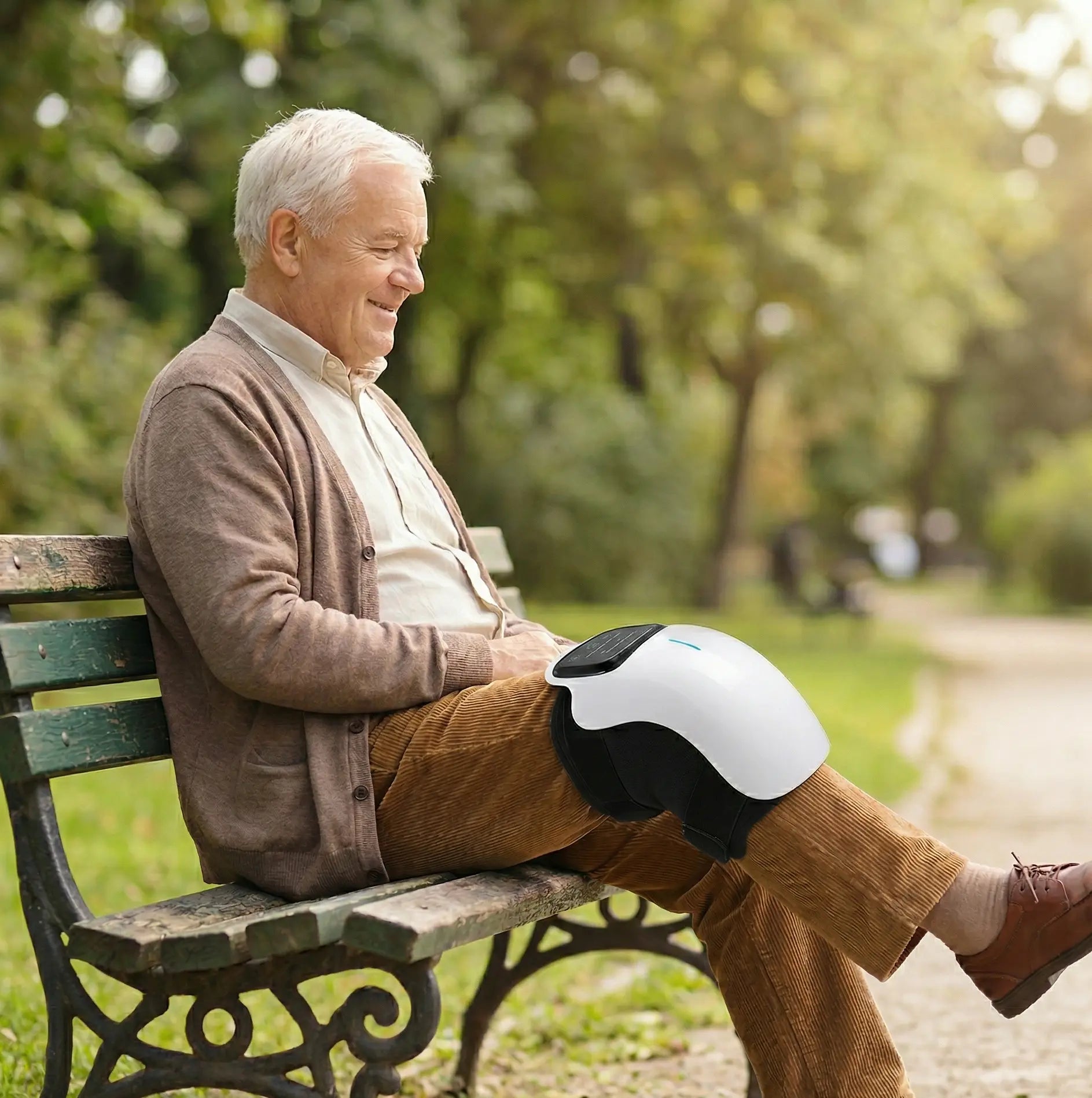 Older_Man_on_Park_Bench_using_lumana_knee_massager